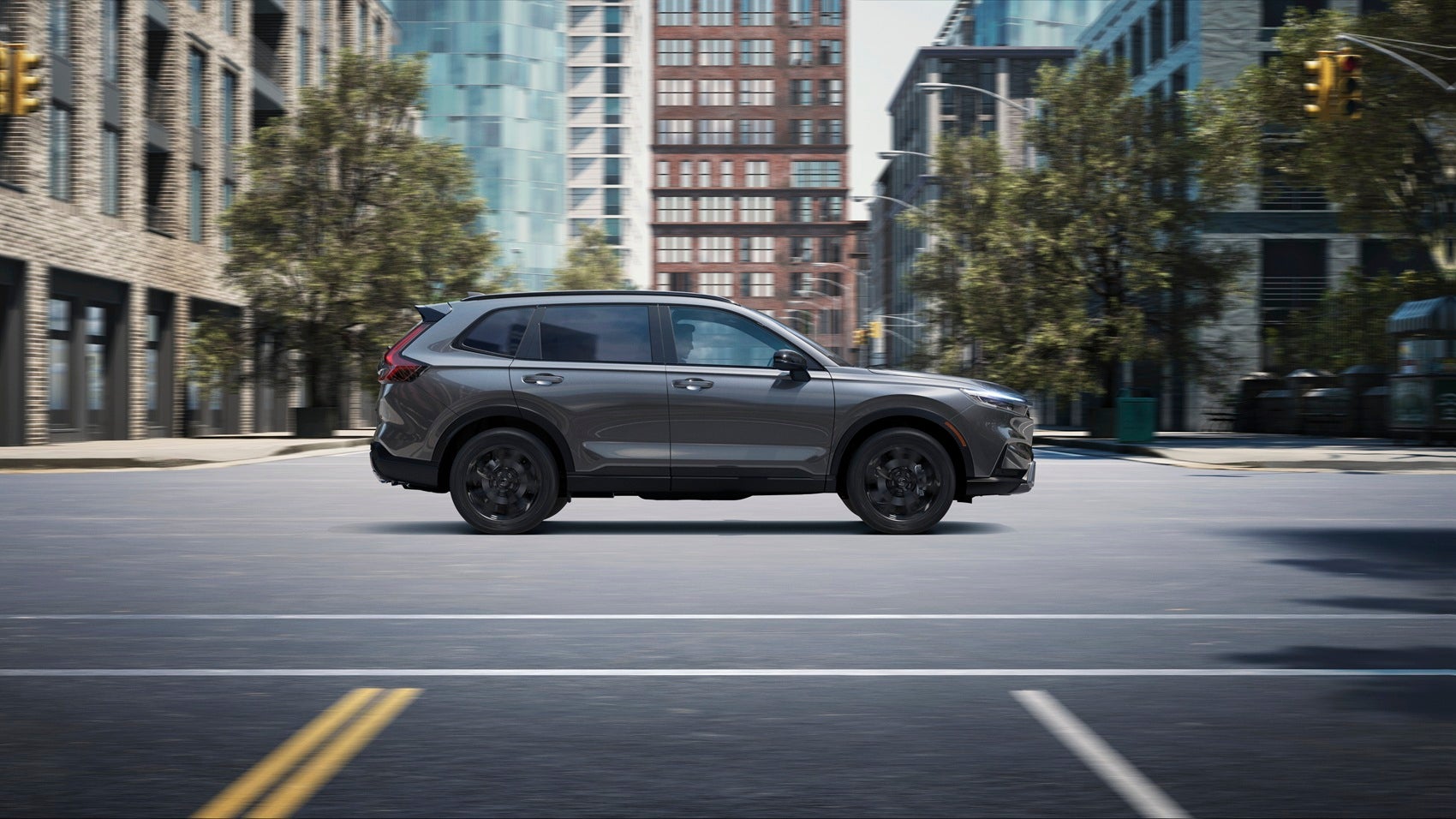  Dark grey Honda CR-V traveling down a busy street on a sunny day